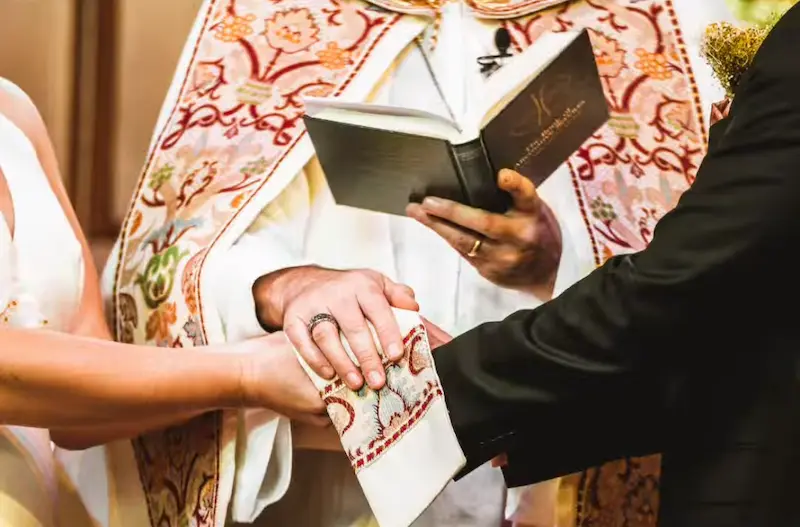 bride and groom being blessed
